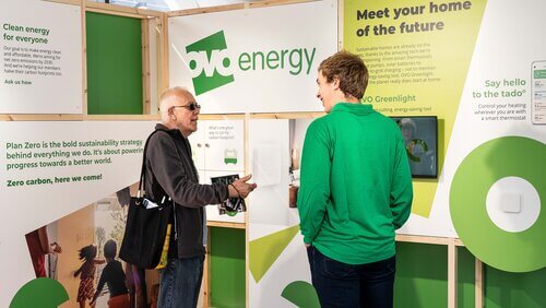 2 men talking in the exhibition booth