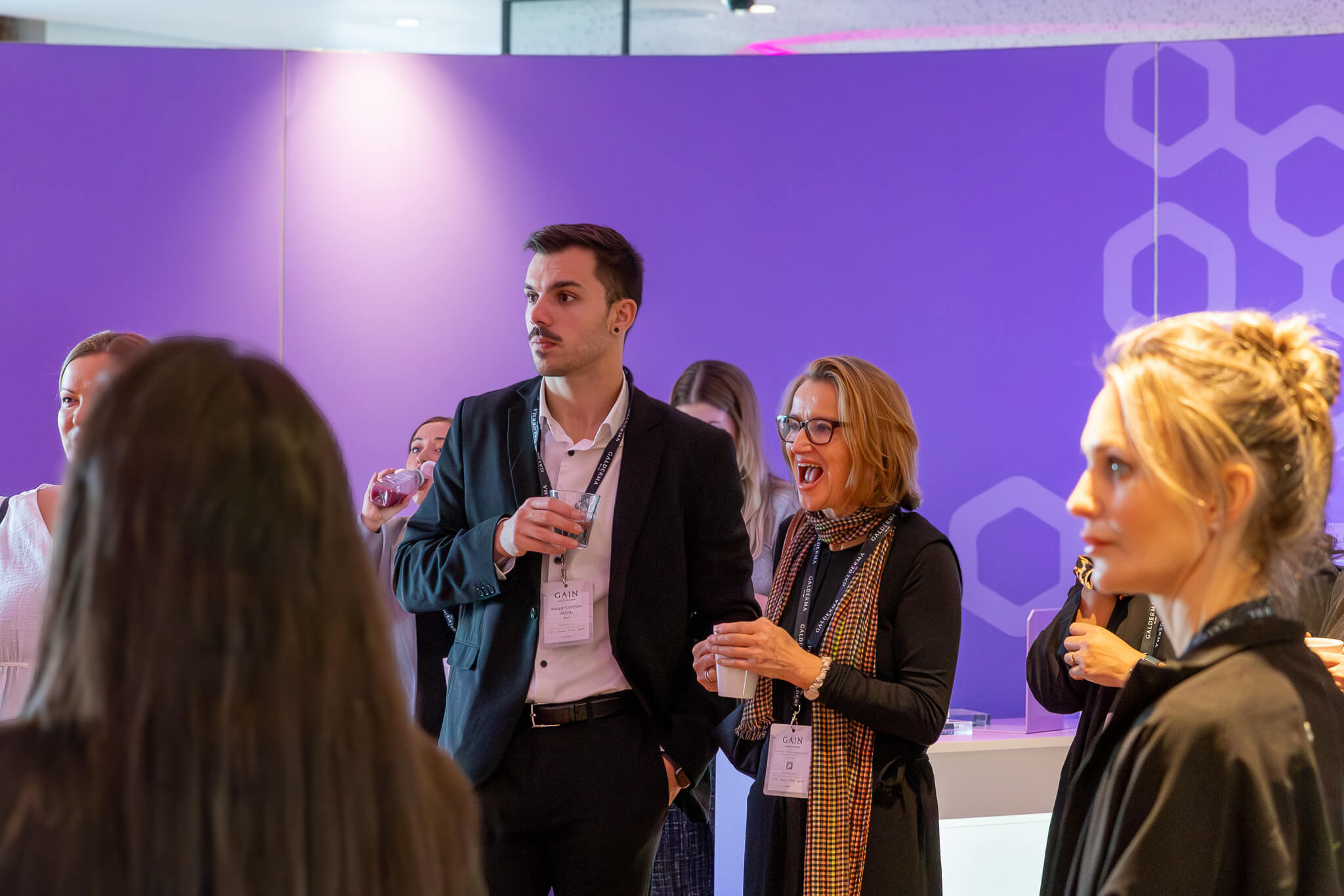 Galderma team talking at the event