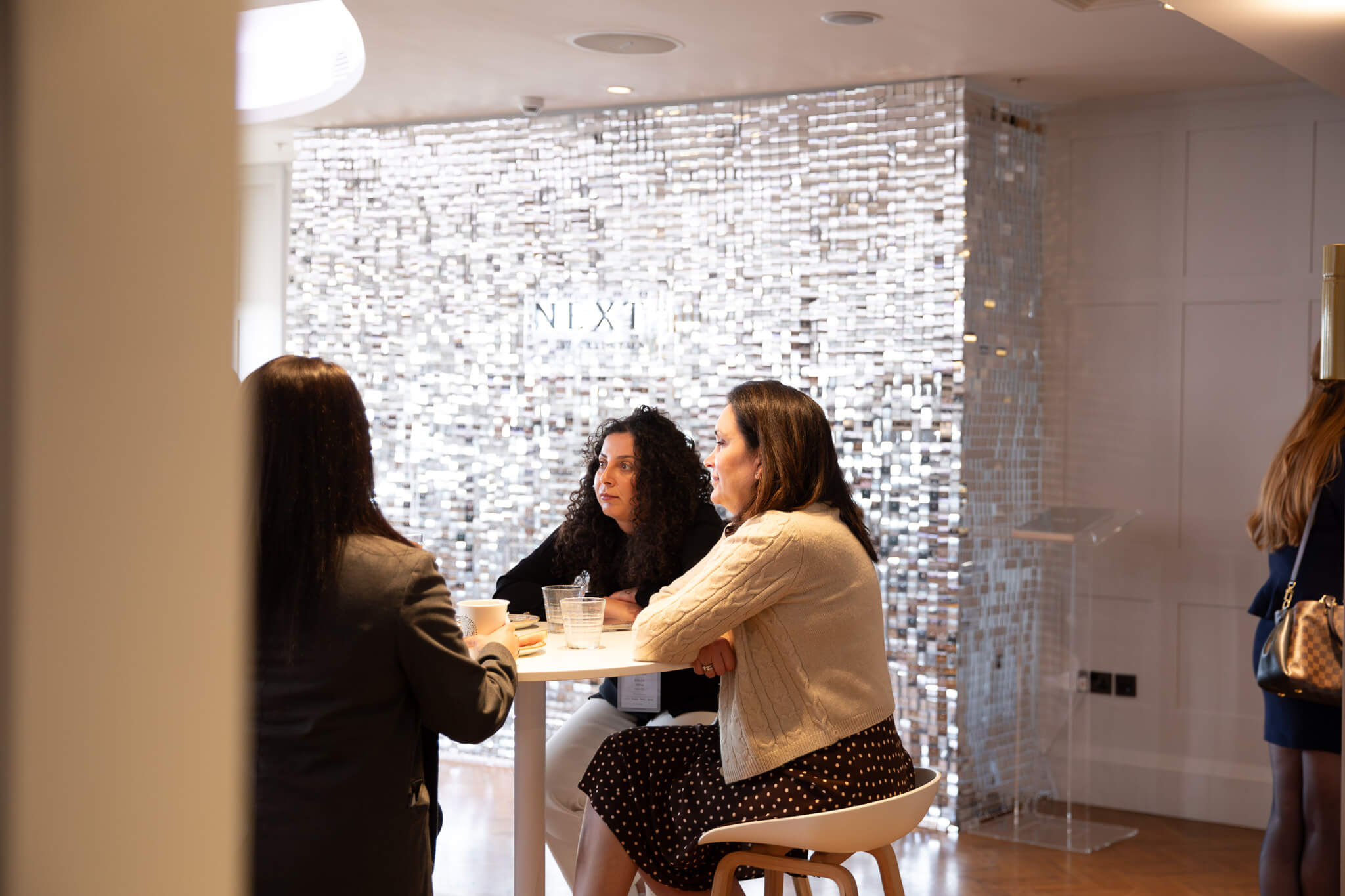 People sat in reception area at high table