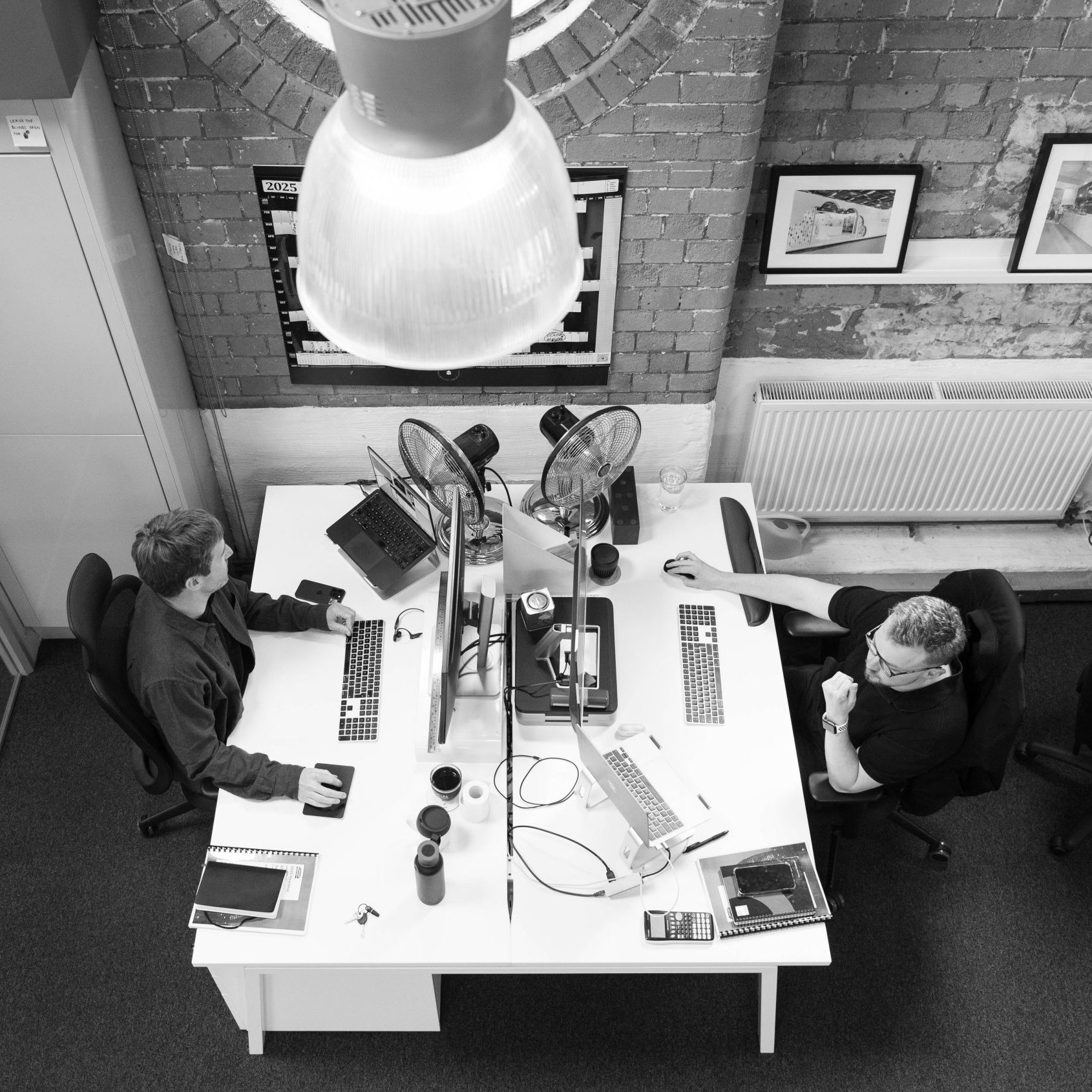 Birds eye view of Bryn and Tom in the office